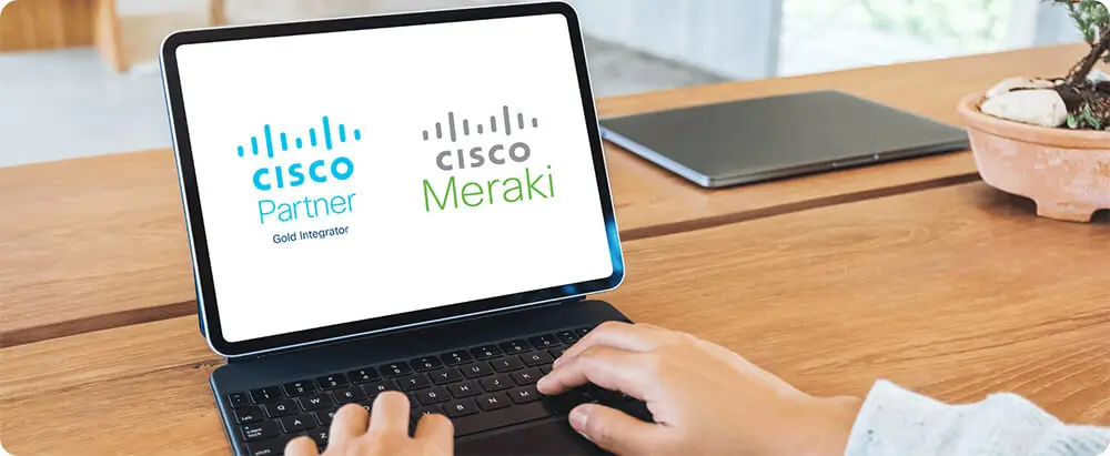 Laptop screen showing logos for Cisco Partner and Cisco Meraki